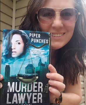 Piper Punches holding The Murder Lawyer